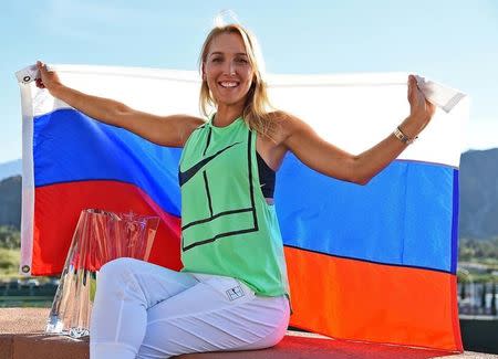 Mar 19, 2017; Indian Wells, CA, USA; Elena Vesnina (RUS) poses with the championship trophy and Russian flag after winning the women's final in the BNP Paribas Open at the Indian Wells Tennis Garden. Mandatory Credit: Jayne Kamin-Oncea-USA TODAY Sports