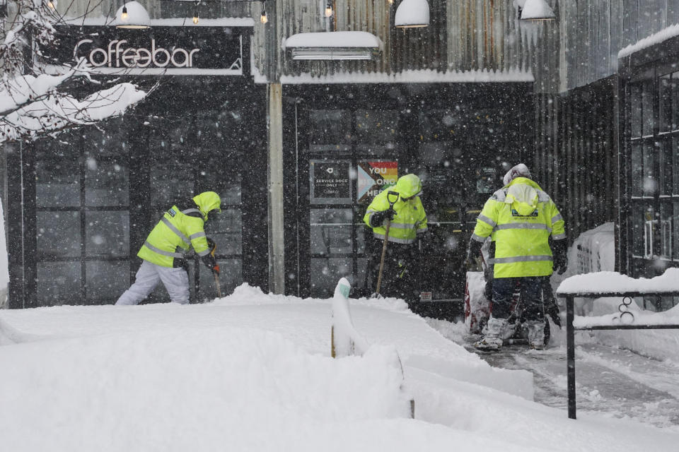 Snow is cleared from the entrance to a business during a storm, Sunday, March 3, 2024, in Truckee, Calif. (AP Photo/Brooke Hess-Homeier)