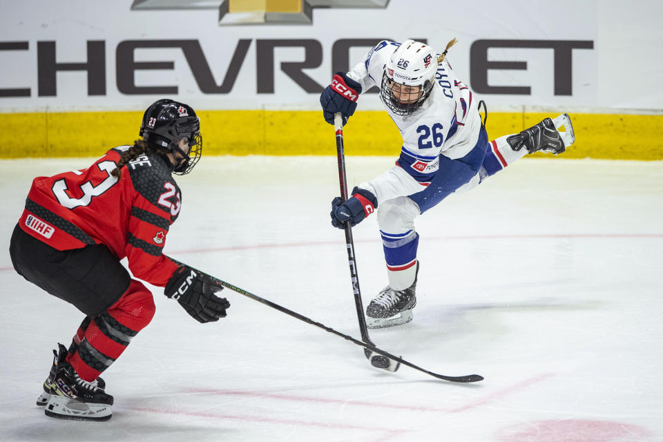 United States' Kendall Coyne Schofield (26) shoots against Canada's Erin Ambrose (23) during the third period of a Rivalry Series hockey game Friday, Feb. 9, 2024, in Regina, Saskatchewan. (Liam Richards/The Canadian Press via AP)