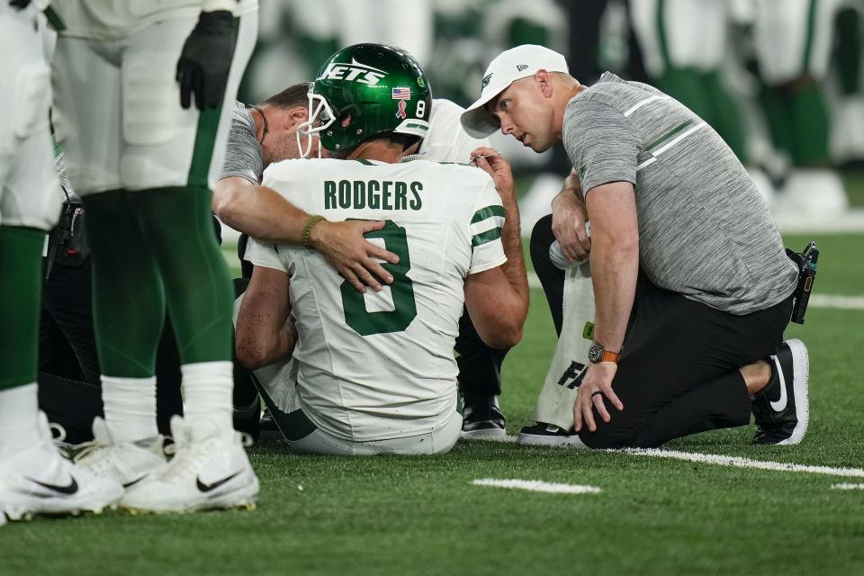 New York Jets quarterback Aaron Rodgers (8) is tended to on the field during the first quarter of an NFL football game against the Buffalo Bills, Monday, Sept. 11, 2023, in East Rutherford, N.J. | Seth Wenig, Associated Press