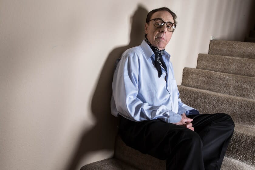 Film director Peter Bogdanovich sits on a staircase