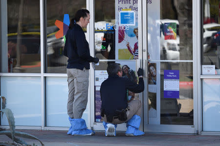 Law enforcement personnel are seen gathering evidence outside a FedEx Store which was closed for investigation, in Austin, Texas, U.S., March 20, 2018. REUTERS/Sergio Flores