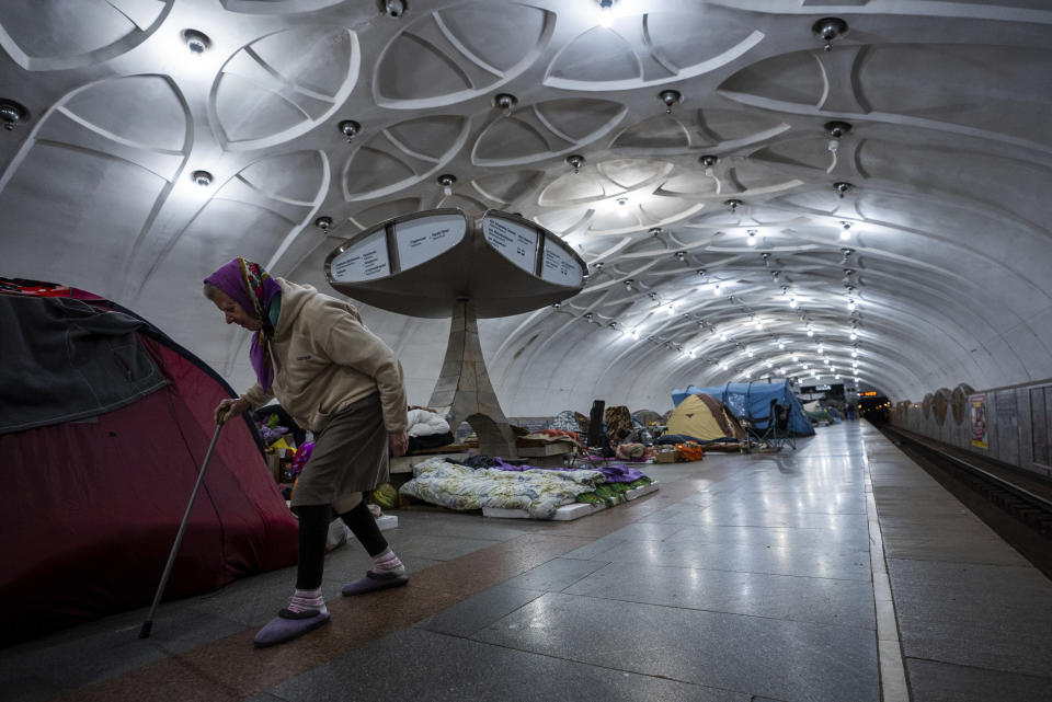 An elderly woman walks inside a metro station being used as a bomb shelter in Kharkiv, Ukraine, Thursday, May 12, 2022. (AP Photo/Mstyslav Chernov)