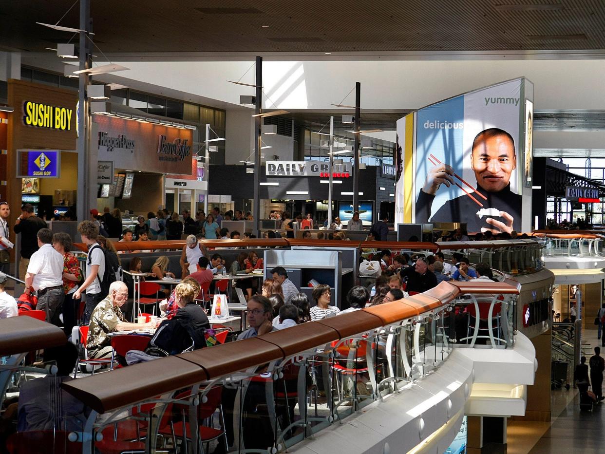 Travelers dine in restaurants and foodcourt at the Tom Bradley International Terminal at LAX Airport.