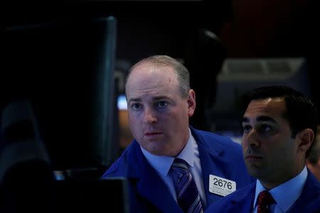 Traders work on the floor of the New York Stock Exchange (NYSE) in New York, U.S., July 5, 2017. REUTERS/Brendan McDermid