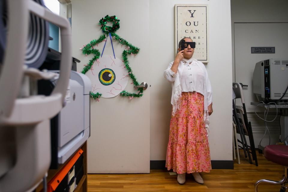 Maria Ovalle performs an eyesight test in an examination room at Caridad Center on Monday in Boynton Beach.