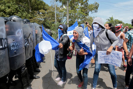 A demonstrator shouts slogans to riot police during a protest against Nicaraguan President Daniel Ortega's government in Managua, Nicaragua September 23, 2018. REUTERS/Oswaldo Rivas