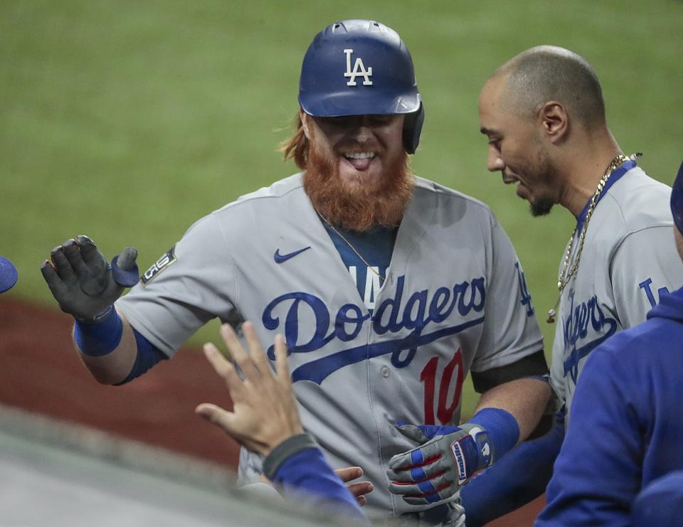 Dodgers third baseman Justin Turner celebrates with Mookie Betts.