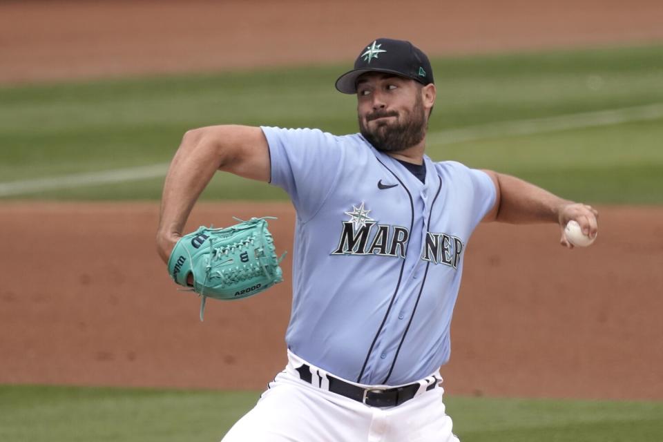 Seattle Mariners pitcher Robbie Ray works against the Texas Rangers on Monday in Peoria, Ariz.