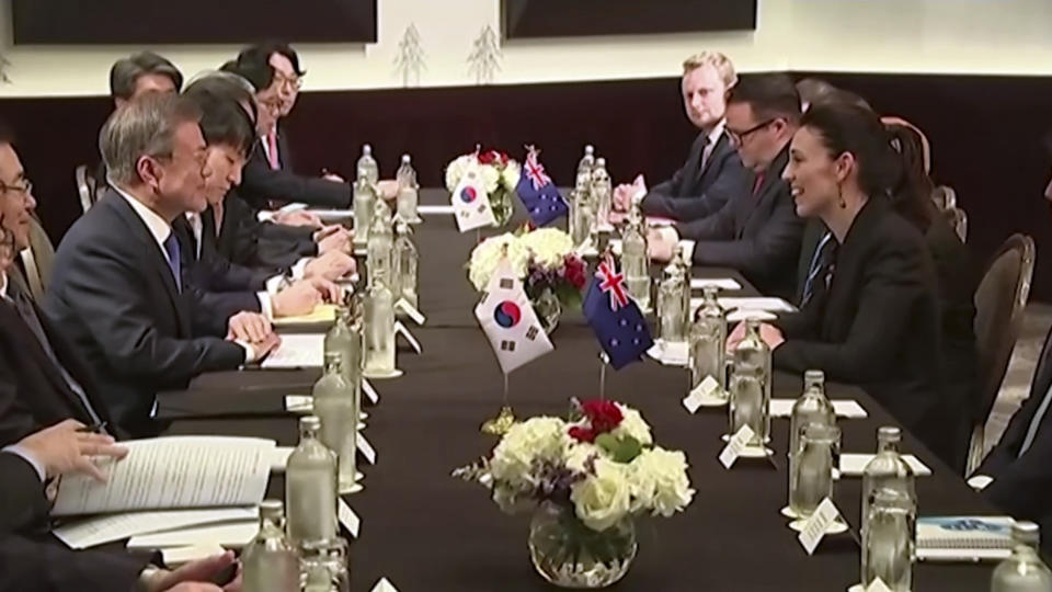 In this image made from a video, New Zealand's Prime Minister Jacinda Ardern, right, and South Korean President Moon Jae-in meet in Auckland, New Zealand Tuesday, Dec. 4, 2018. Ardern says New Zealand will soon allow smoother immigration procedures for visitors from South Korea and plans to improve pension portability between the two countries. (NZ POOL via AP)