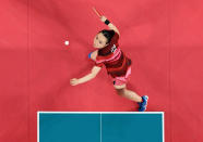 <p>Japan's Mima Ito hits a shot against China's Xu Xin and Liu Shiwen (not pictured) in their July 26 mixed doubles table tennis final match.</p>