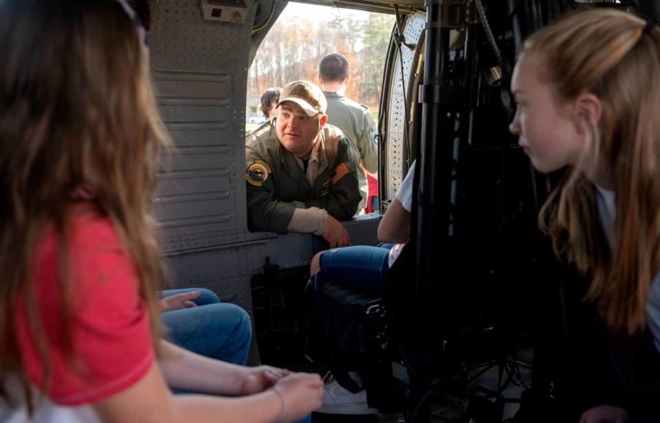 Marcus Burke from the Navy VX-1 talks to Bald Eagle Area students as they sit in the helicopter that was flown to the Veterans Day celebration on Thursday, Nov. 9, 2023. Abby Drey/adrey@centredaily.com