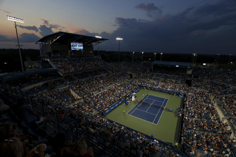 Felix Auger-Aliassime, of Canada, and Stefanos Tsitsipas, of Greece, pause during a match at the Western & Southern Open tennis tournament after sunset Friday, Aug. 20, 2021, in Mason, Ohio. (AP Photo/Aaron Doster)
