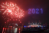 Fireworks and drones illuminate the night sky over the The O2 in London as they form a light display as London's normal New Year's Eve fireworks display was cancelled due to the coronavirus pandemic. (Photo by Victoria Jones/PA Images via Getty Images)