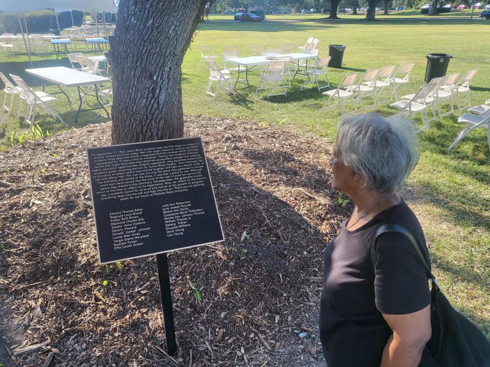 Lois Young Blanchard, 79, looks at the plaque commemorating the first 21 Black students to integrate at Nicholls State University in September of 1963. She was one of the first seven students to integrate. The tree was a location the group would gather to escape the animosity they faced.