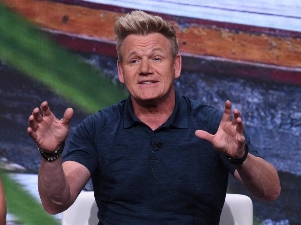 Gordon Ramsay with an animated facial expression and his hands up in the air.
