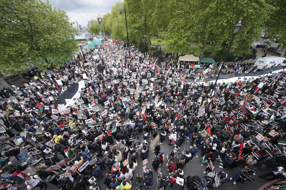 Protesters gather in central London, Saturday May 22, 2021, and take part in a rally in support of Palestinians. Egyptian mediators held talks Saturday to firm up an Israel-Hamas cease-fire as Palestinians in the Hamas-ruled Gaza Strip began to assess the damage from 11 days of intense Israeli bombardment. (Yui Mok/PA via AP)