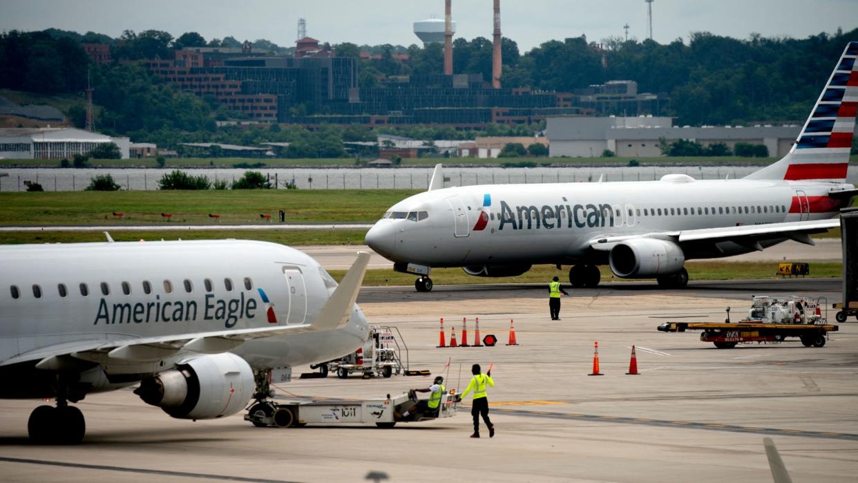  An American Airlines plane and an American Eagle plane pass each other. 