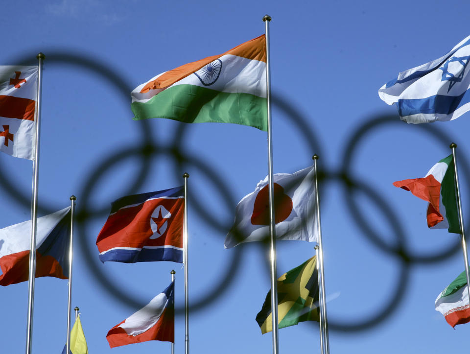 <p>The North Korean flag, center, flies amongst flags from many nations as they fly at the Olympic Village ahead of the 2018 Winter Olympics in PyeongChang, South Korea. (AP) </p>