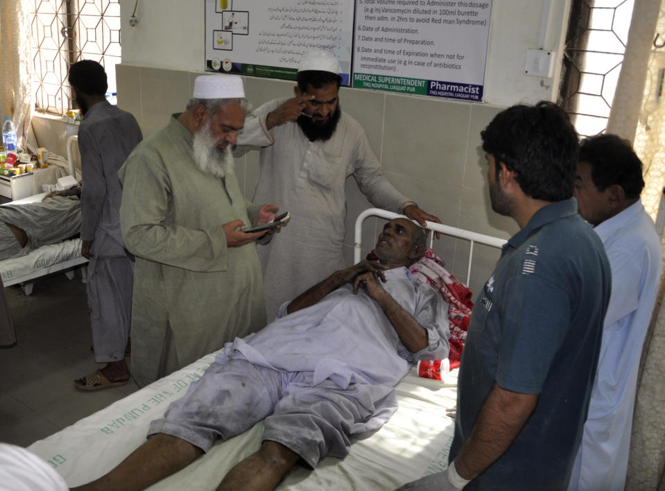 People visit victims of a train fire, at a local hospital in Liaquatpur, Pakistan, Thursday, Oct. 31, 2019. A massive fire engulfed three carriages of the train traveling in the country's eastern Punjab province (AP Photo/Siddique Baluch)