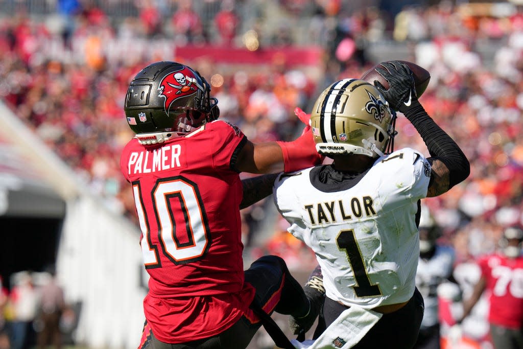 New Orleans Saints cornerback Alontae Taylor (1) intercepts a pass intended for Tampa Bay Buccaneers wide receiver Trey Palmer (10) in the first half of an NFL football game in Tampa, Fla., Sunday, Dec. 31, 2023. (AP Photo/Chris O'Meara)
