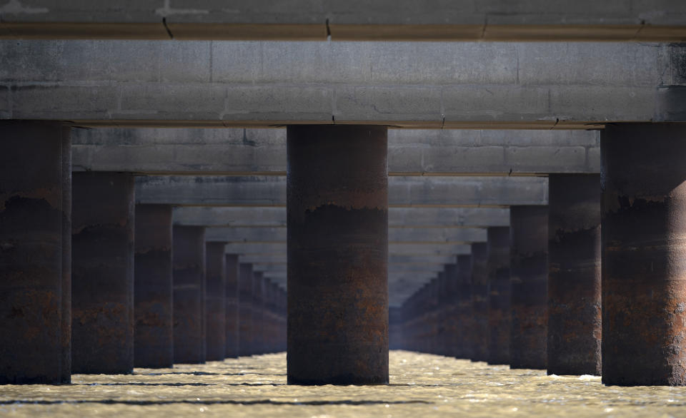 FILE - In this July 29, 2021 file photo, the pillars of the massive Rosario-Victoria Bridge are exposed during a drought affecting the Parana River near Rosario, Argentina. At the port city of Santa Fe the river registered a level of 22 centimeters, the lowest in 50 years. (AP Photo/Victor Caivano, File)