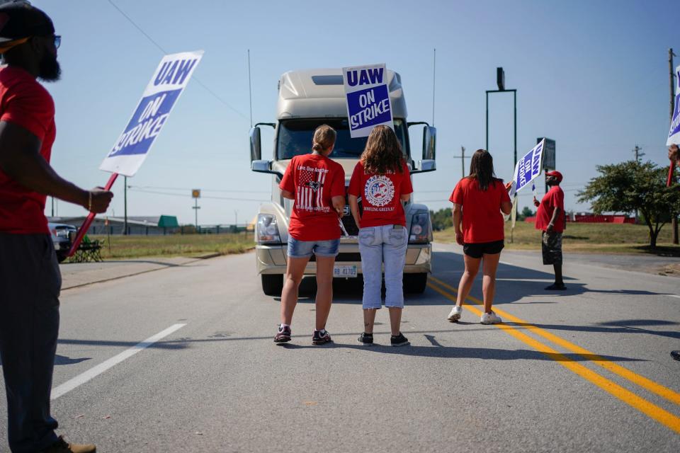 Striking plant workers block the passage of a truck outside the General Motor assembly plant in Bowling Green, Ky, Sept. 16, 2019.