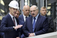 Belarusian President Alexander Lukashenko, right, visits the largest construction company in Belarus, Friday, Sept. 18, 2020, in Minsk. (Maxim Guchek/BelTA Pool Photo via AP)