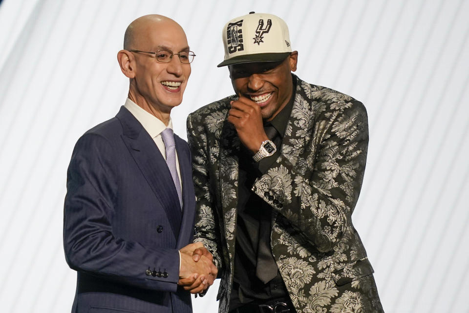 Malaki Branham reacts as he shakes hands with NBA Commissioner Adam Silver after being selected 20th overall in the NBA basketball draft, Thursday, June 23, 2022, in New York. (AP Photo/John Minchillo)