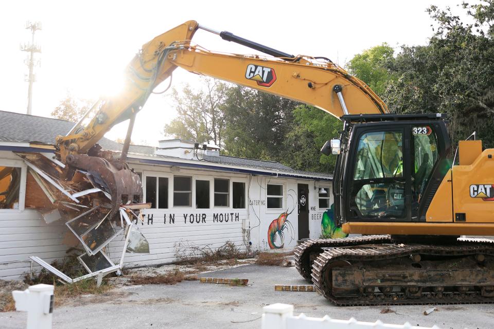 Brooksie Terrell of J.B. Coxwell Contracting Inc. makes the first stab as he works an excavator to raze the former Beach Road Fish House & Chicken Dinners restaurant building Wednesday morning in Jacksonville. After 84 years, the landmark restaurant originally known as Beach Road Chicken Dinners was demolished to clear the way for a luxury apartment community.