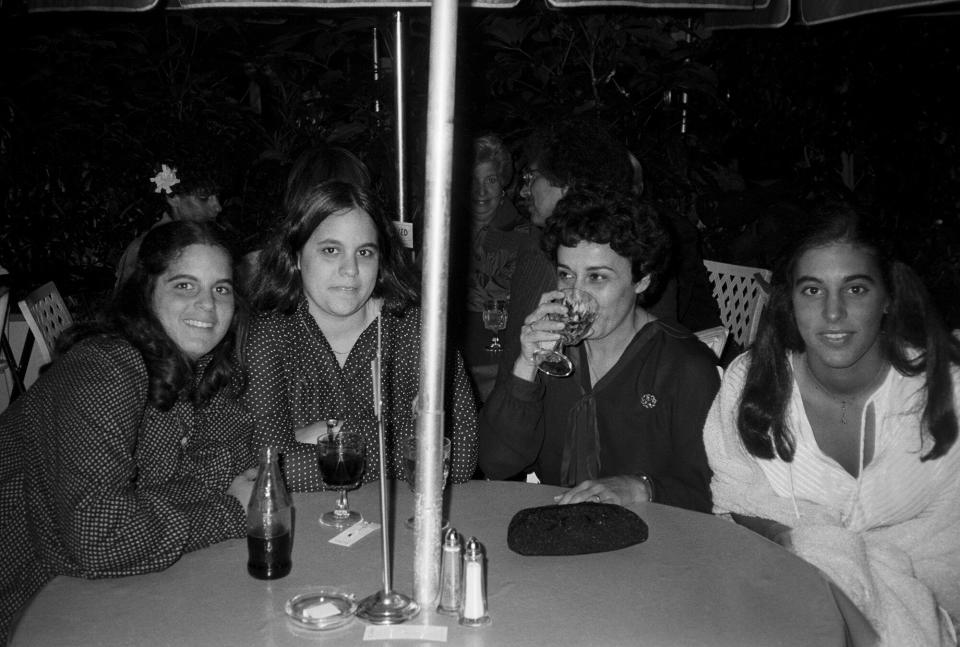 Alan Alda's daughters with their mother Arlene Alda (3rd from left) at an outdoor party; circa 1970; New York