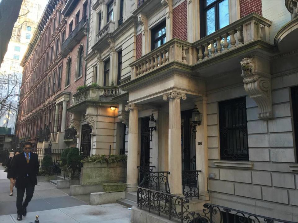 A man walks in front of 116 E. 65th St., the New York City home that Ghislaine Maxwell owned from 2000 to 2016 through a secretive corporation whose address listed Jeffrey Epstein’s nearby New York mansion. The potential tangling of their money is one of the intrigues in the settlement of the disgraced financier’s estate.