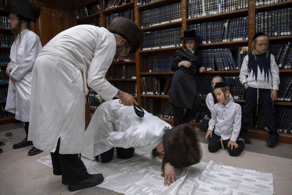 An ultra-Orthodox Jewish man whips a member of his Hasidic dynasty with a leather strap as a symbolic punishment for his sins last year, during the traditional Malkot (whipping in Hebrew) ceremony, ahead of Yom Kippur that begins at sunset, in the city of Beit Shemesh, near Jerusalem, Wednesday, Sept. 15, 2021. Yom Kippur is Judaism's day of atonement, when devout Jews ask God to forgive them for their transgressions and refrain from eating and drinking, attending intense prayer services in synagogues. (AP Photo/Oded Balilty)