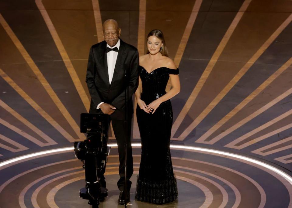 hollywood, california march 12 l r morgan freeman and margot robbie speak onstage during the 95th annual academy awards at dolby theatre on march 12, 2023 in hollywood, california photo by kevin wintergetty images