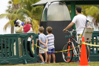 A health care worker, left, administers a COVID-19 test at a mobile walk-up testing site at Crandon Park, Saturday, Nov. 28, 2020, in Miami. (AP Photo/Lynne Sladky)