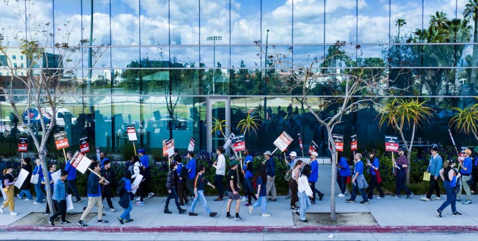 WGA members walk a picket line around the Bronson Sunset Studios lot.