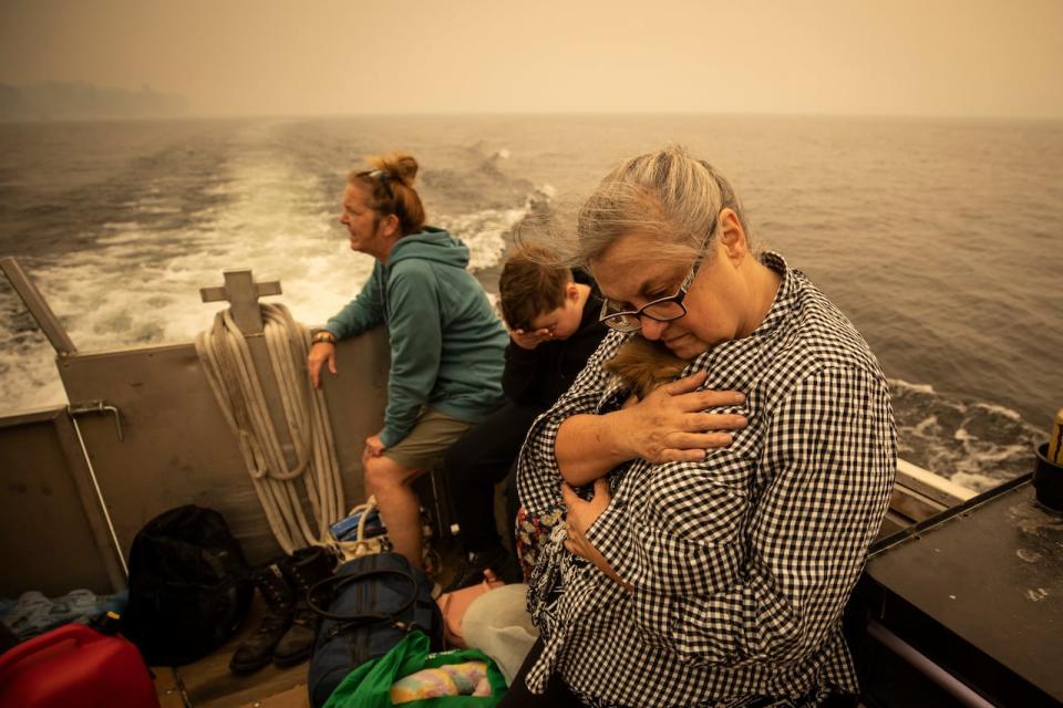 Evacuees are pictured while taking a boat to Celista, British Columbia on Saturday, Aug. 19, 2023.