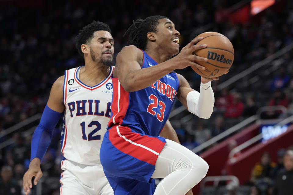 Detroit Pistons guard Jaden Ivey (23) attempts a layup as Philadelphia 76ers forward Tobias Harris (12) defends during the second half of an NBA basketball game, Sunday, Jan. 8, 2023, in Detroit. (AP Photo/Carlos Osorio)