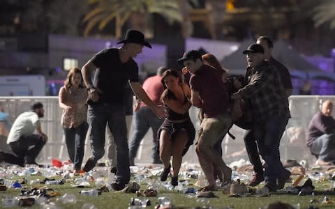  People carry a peson at the Route 91 Harvest country music festival after - Credit: David Becker/Getty