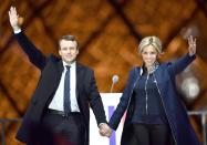 <p>In a navy blue jacket and top with her husband after he won the 2017 French election at the Esplanade du Louvre in Paris, France.</p>