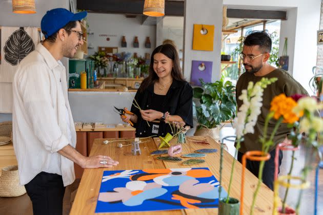 Dom Cordilla, Lucy Angel Camarena and Miguel Cervantes set new pieces from Mexico for Comercio Popular along with flowers from Flores Campo. (Photo: Jesus J. Montero for HuffPost)