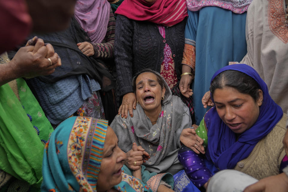 Family members and relatives cry after a boat carrying people including children capsized in Jhelum river on the outskirts of Srinagar, Indian controlled Kashmir, Tuesday, April. 16, 2024. Rescue operation is continuing for the several missing people. (AP Photo/Mukhtar Khan)