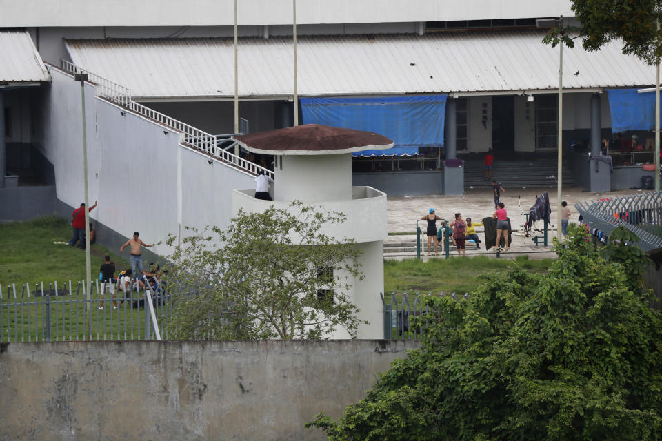 In this June 1, 2019 photo, migrants mill around in the courtyards of the Siglo XXI migrant detention center in Tapachula, Chiapas state, Mexico. Located near the border with Guatemala, it's a secretive place off-limits to public scrutiny where cellphones are confiscated and journalists aren't allowed inside. (AP Photo/Marco Ugarte)