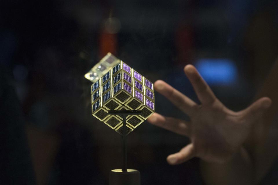 The world's most expensive Rubik's Cube is displayed during an exhibition, while people attend the National Rubik's Cube Championship at Liberty Science Center in Jersey City