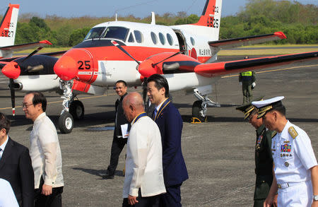 Philippine National Defense Secretary Delfin Lorenzana and Japanese parliamentary Vice Minister for Defence Tatsuo Fukuda walk past one of the three units of Beechcraft TC90 aircraft from the Japan Ministry of Defense (JMOD) at a transfer ceremony of the aircrafts to the Philippine Navy at the Naval Air Group (NAG) headquarters in Sangley Point, Cavite city, Philippines March 26, 2018. REUTERS/Romeo Ranoco