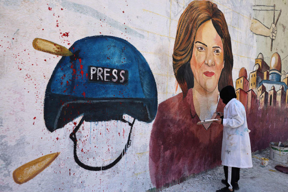 <div class="inline-image__caption"><p>Palestinian artists paint a mural in honor of slain veteran Al-Jazeera journalist Shireen Abu Akleh in Gaza City on May 12.</p></div> <div class="inline-image__credit">Mohammed Abed/AFP via Getty</div>