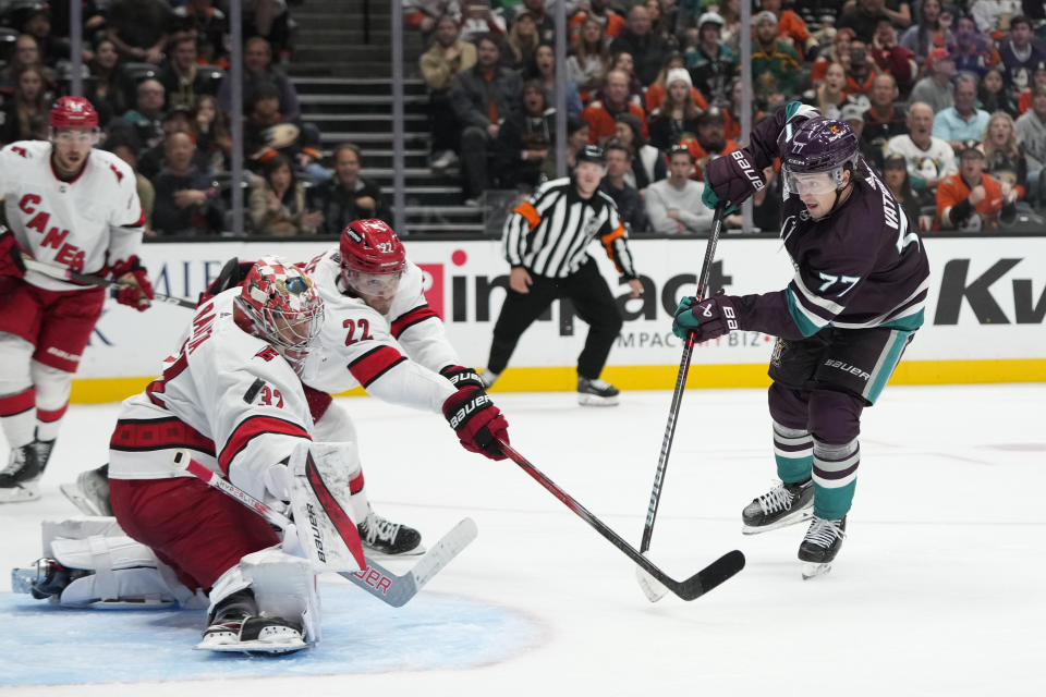 Carolina Hurricanes goalie Antti Raanta (32) makes a save against Anaheim Ducks' Frank Vatrano (77) during the third period of an NHL hockey game, Sunday, Oct. 15, 2023, in Anaheim, Calif. The Ducks won 6-3. (AP Photo/Jae C. Hong)