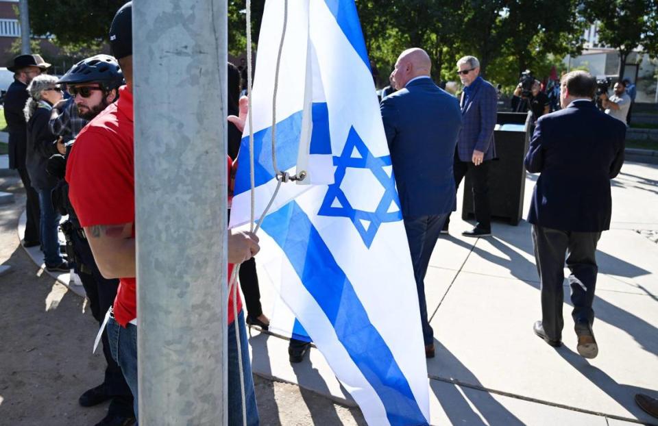 The Israeli flag is attached to the flag pole before raising as the City of Fresno held a ceremony at Eaton Plaza showing solidarity with Israel Thursday, Oct. 12, 2023 in downtown Fresno.