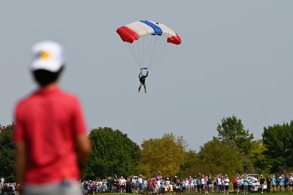 Fans watch a parachute land during the final round of the LIV Golf Chicago tournament at Bolingbrook Golf Club. Mandatory Credit: Matt Marton-Imagn Images