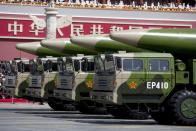 FILE PHOTO: Military vehicles carrying DF-26 ballistic missiles travel past Tiananmen Gate during a military parade to commemorate the 70th anniversary of the end of World War II in Beijing